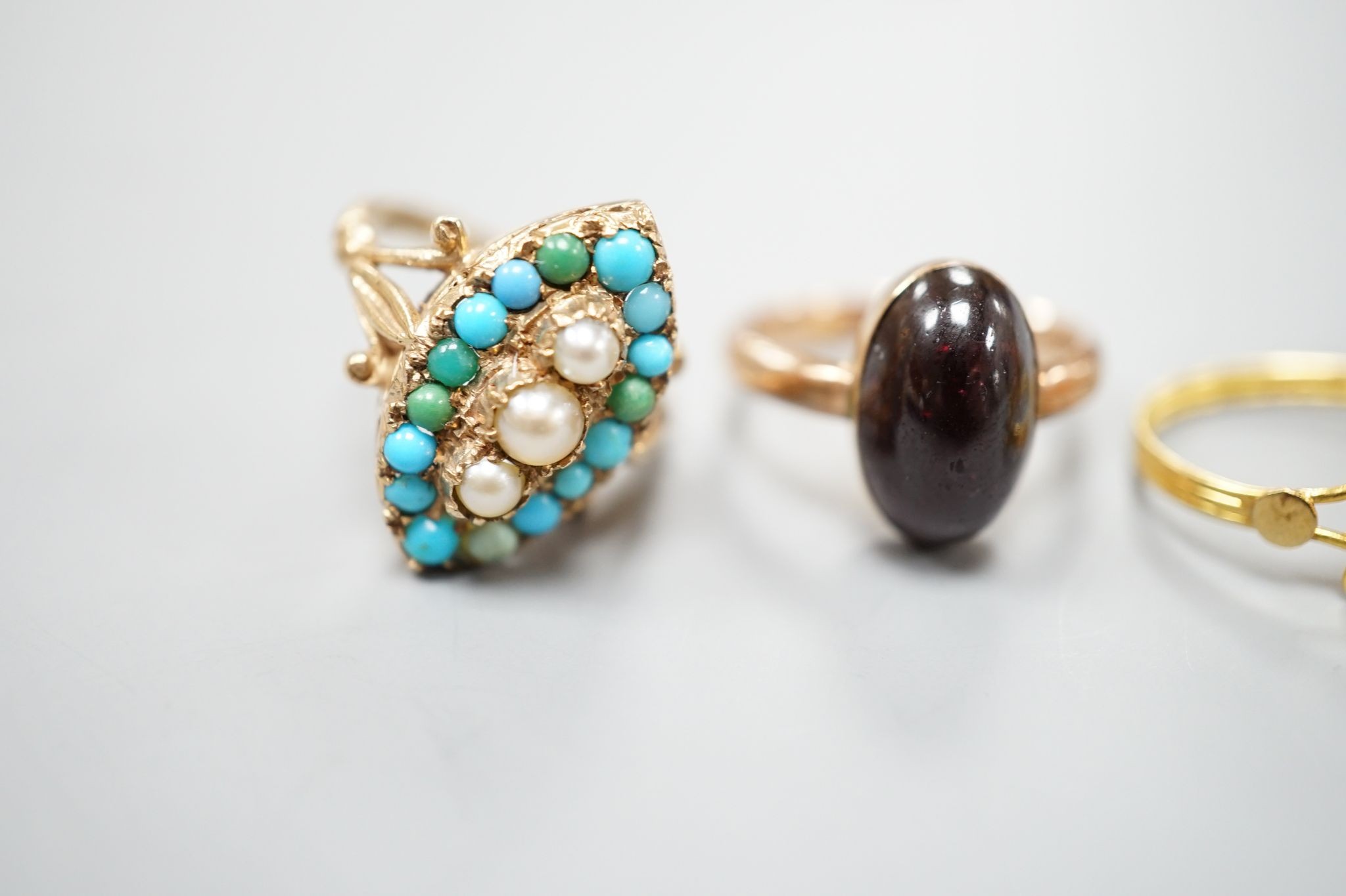 Three assorted modern 9ct gold and gem set ring including turquoise and seed pearl, gross 11.2 grams, a 10k and coral set ring, gross 2.7 grams and a yellow metal and turquoise set ring, gross 1.3 grams.